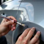 Applying touch-up paint to a car scratch