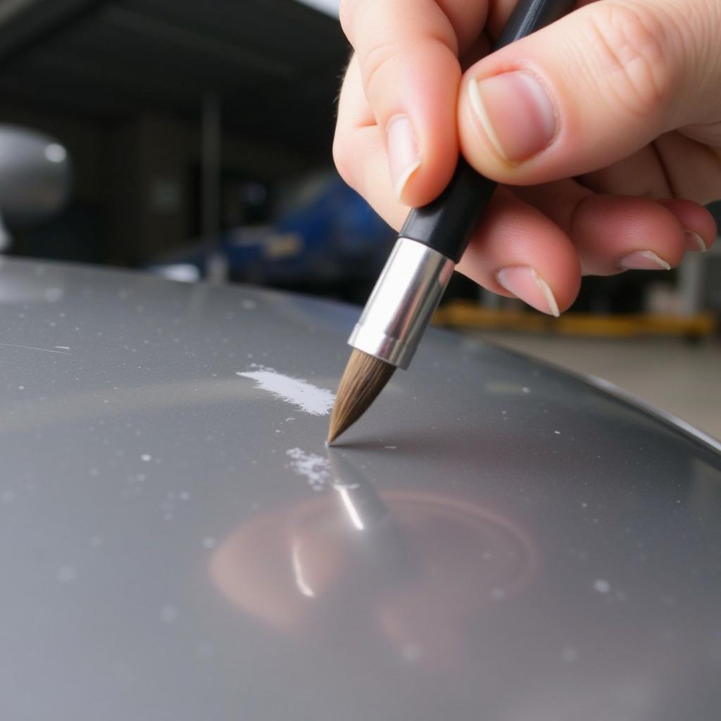 Applying touch-up paint to a car scratch using a fine-tipped brush