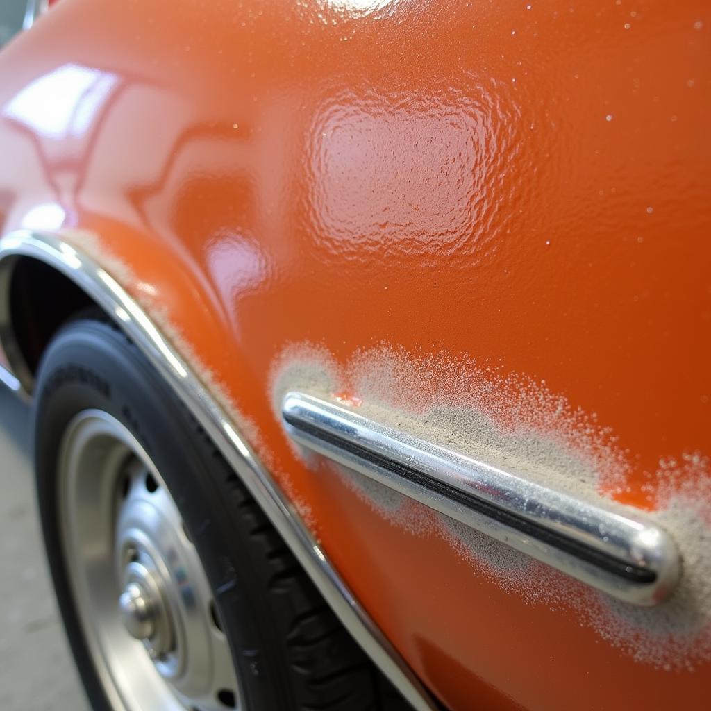 Bad Car Paint Job Showing Orange Peel and Overspray