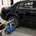 Hydraulic Frame Straightening on a Black Car