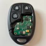 Close-up of a broken car key fob showing internal damage and a cracked casing