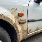 Car body with visible mold damage due to moisture exposure