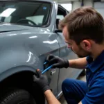 Car body panel repair shop near me, showing a technician assessing damage to a vehicle's fender.