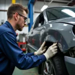 Apprentice Working on Car Body Repair