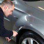 Car body repair in Banbury focusing on dent removal process.