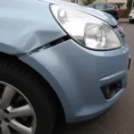 Car with Damaged Bumper and Scratched Fender in Cheshire