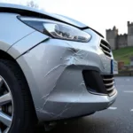 Damaged bumper of a car needing repair in Conwy