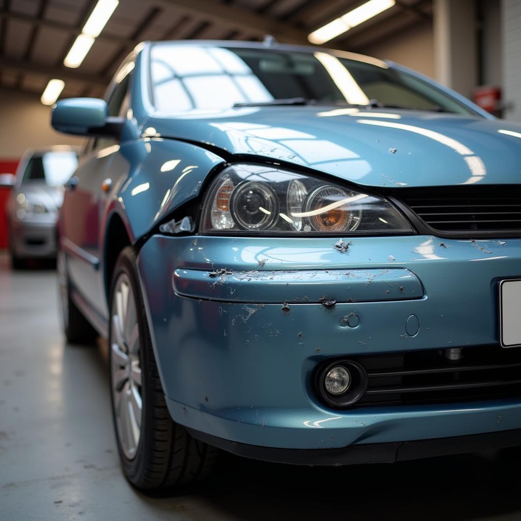 Car with body damage in Ellesmere Port awaiting repair