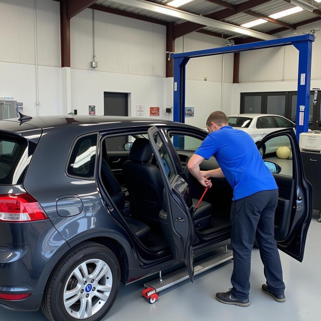 Car body repair shop in Longton with skilled technicians working on a damaged vehicle