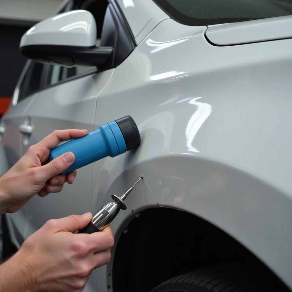 Car body repair in Sandhurst showing dent removal process