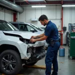 Car Body Repair Shop in Kenilworth Showing a Technician Working on a Damaged Vehicle