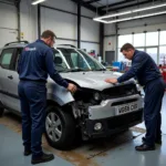 Medway Kent Car Body Repair Shop: Technicians working on a damaged car.