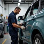 Car body repair shop in Moray showing a technician working on a damaged vehicle