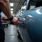 Car body repair in Warwickshire showing dent removal process on a damaged vehicle