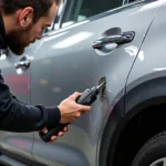 Car bodywork repair in Brighton showing dent removal process