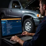 Mechanic using car diagnostic software on a laptop