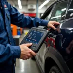 Car diagnostic tools being used by a technician in a car repair center