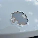 Close-up of a paint chip on a car hood