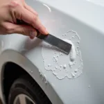 Removing Car Paint Bubbles with a Razor Blade