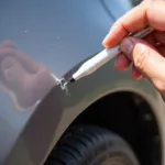 Applying Car Paint Pen for Precise Scrape Repair