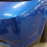 Damaged car bumper needing paint repair in Darlington