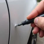 Applying Car Paint Repair Pen to Car Scratch