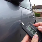 Car Scratch Repair Bromley: Close-up of a minor scratch on a car's bodywork in Bromley, being assessed for repair.