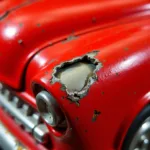 Close-up of chipped paint on a red Matchbox car