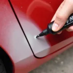 Applying Fix It Pro Pen to Car Scratch