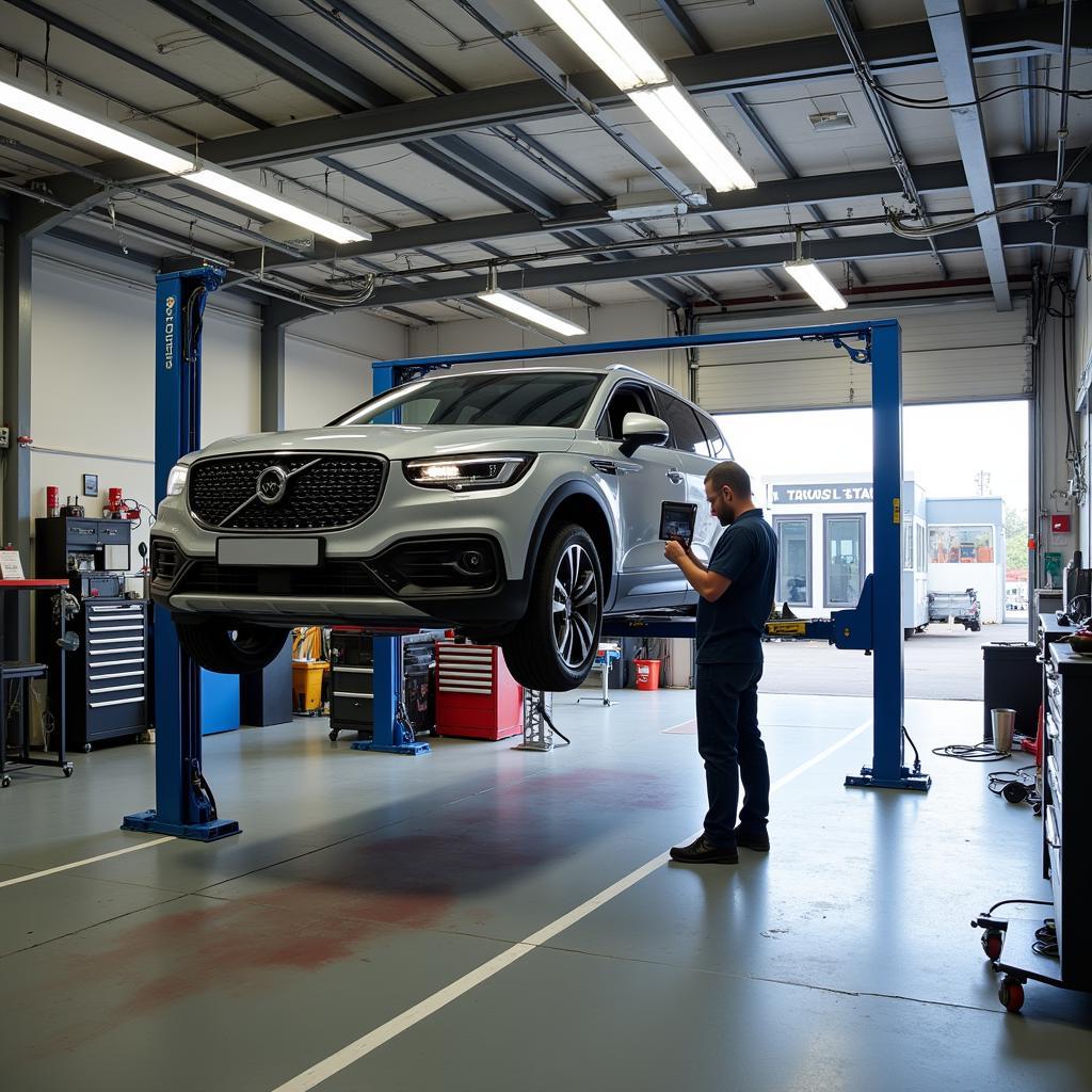 Modern car repair equipment inside a spacious workshop in an industrial estate, including lifts, diagnostic tools, and spray booths.