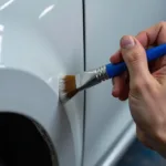 Applying touch-up paint to a keyed car scratch