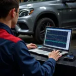 Mechanic Analyzing Diagnostic Data on a Laptop