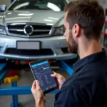 Mechanic Using Car Diagnostic Software in a Garage