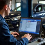 Mechanic using car diagnostic software on laptop connected to a car's OBD-II port.