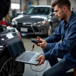 A mechanic uses car diagnostic software on a laptop to troubleshoot a car problem.