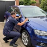 Mobile car paint repair technician working on a car in Essex