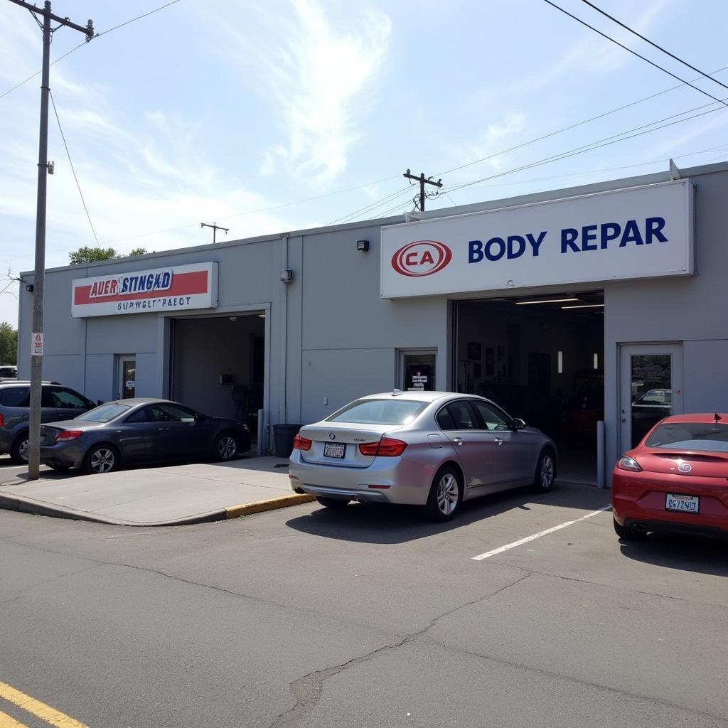 Exterior view of a car body repair shop on Progress Road