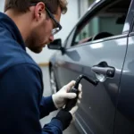 Technician Operating a Dent Puller